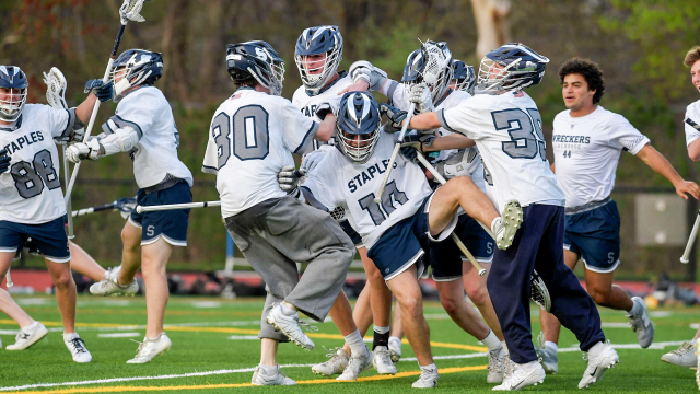 Staples (Conn.) lacrosse players celebrate after victory over New Canaan (Conn.)