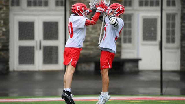 Ryan Goldstein and Willem First jumping in the air and high-fiving each other after a Cornell goal.