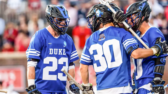 Aidan Maguire's Duke lacrosse teammates come to celebrate with him after an open-net goal against the 10-man ride at Richmond.