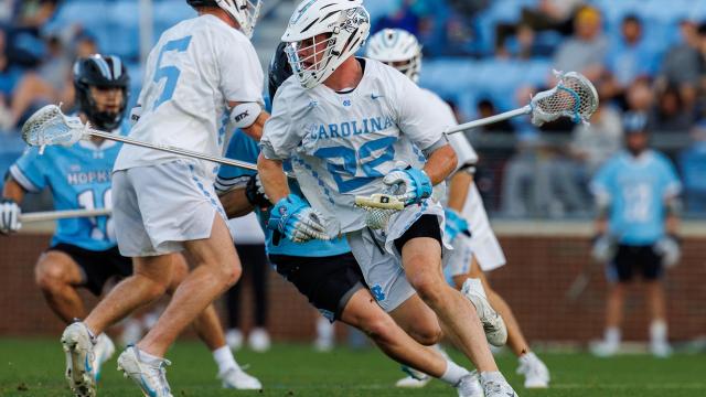 North Carolina's Brady Wambach with the ball after winning a faceoff against Johns Hopkins