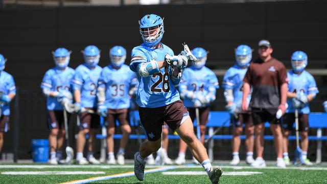 Chase Beyer of Tufts cradles the lacrosse ball