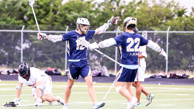 Dallas Jesuit (Texas) lacrosse players celebrate a goal