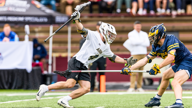 Evan Plunkett of Army men's lacrosse swim dodges a Michigan defenseman during a game played in his native Georgia earlier this spring