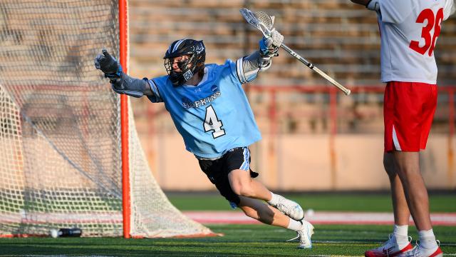 Jimmy Ayers celebrates with arms up after scoring the game-winning goal for Johns Hopkins.