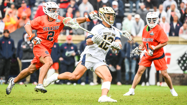 Notre Dame's Josh Yago sprints past the outstretched stick of a Syracuse defender in the NCAA semifinals at Scott Stadium in Charlottesville, Va.