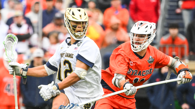 Notre Dame's Josh Yago dodges a Syracuse defenseman during the NCAA semifinals at Scott Stadium in Charlottesville, Va.