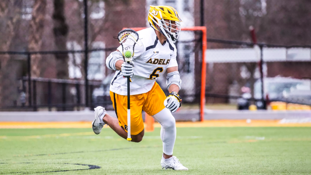 Kyle Lewis of Adelphi men's lacrosse with ball in stick dodging