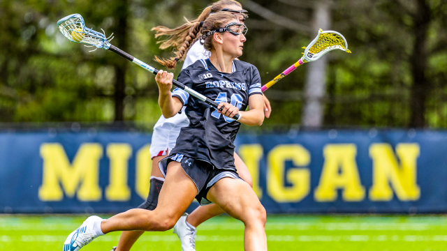 Hopkins lacrosse player Lacey Downey takes on a Maryland defender in the Big Ten semifinals at Michigan.