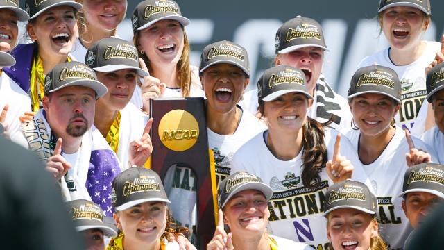 Northwestern players pose with the NCAA trophy