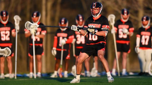 RIT defensemen with his teammates in the background