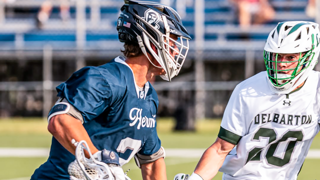 A St. Augustine boys' lacrosse player carries the ball against a Delbarton defender in New Jersey high school action