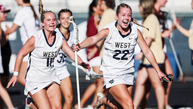 West Forsyth (Ga.) girls' lacrosse players storm the field after their state title victory.
