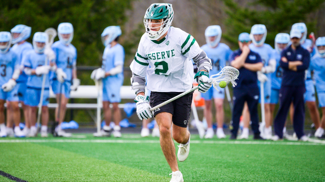 A Western Reserve (Ohio) lacrosse player running with ball up the field