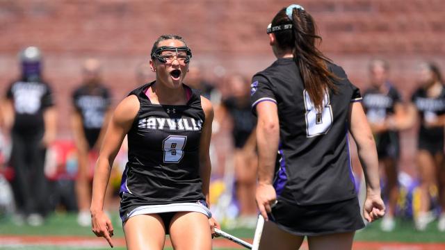 Sayville (N.Y.) girls' lacrosse players Carly Cangelosi (9) and Morgan Farrell (8) find each other to celebrate a goal in the state championship game at Cortland.