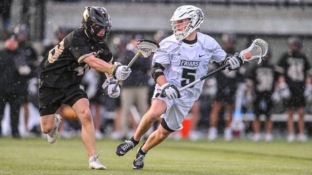 Providence lacrosse player Rhett Chambers surveys options during a February 2026 game against Bryant.