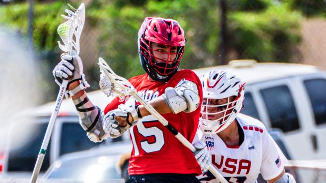 Canada's Jake Stevens withstands harassment from a USA defender during the Pan-American Men's Lacrosse Championship final at Stadium East in Kingston, Jamaica.