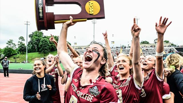 Charlotte North hoists the NCAA championship trophy at Towson's Johnny Unitas Stadium in 2021.
