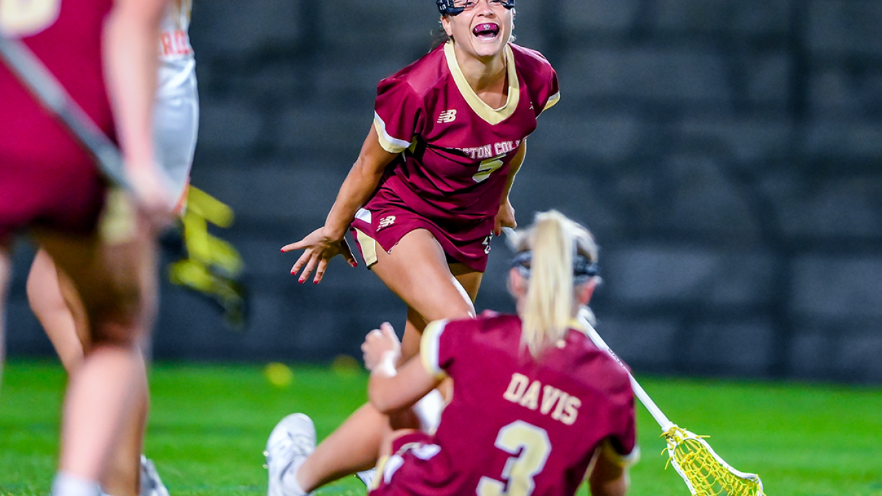Belle Smith (5) and Mckenna Davis celebrate after connecting on Davis' goal with 1:21 remaining to lift Boston College to a 17-16 comeback win over previously unbeaten Syracuse at SU Soccer Stadium.