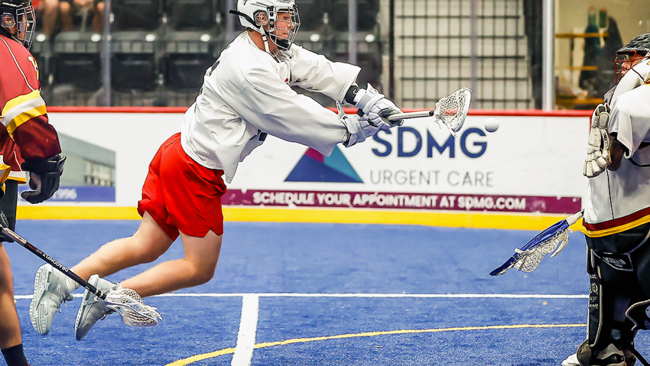 USA White forward CJ Kirst shoots an airborne twister against Snake Island Muskies goalie Edmund Cathers in the North American Invitational championship game Saturday at the Utica University Nexus Center.