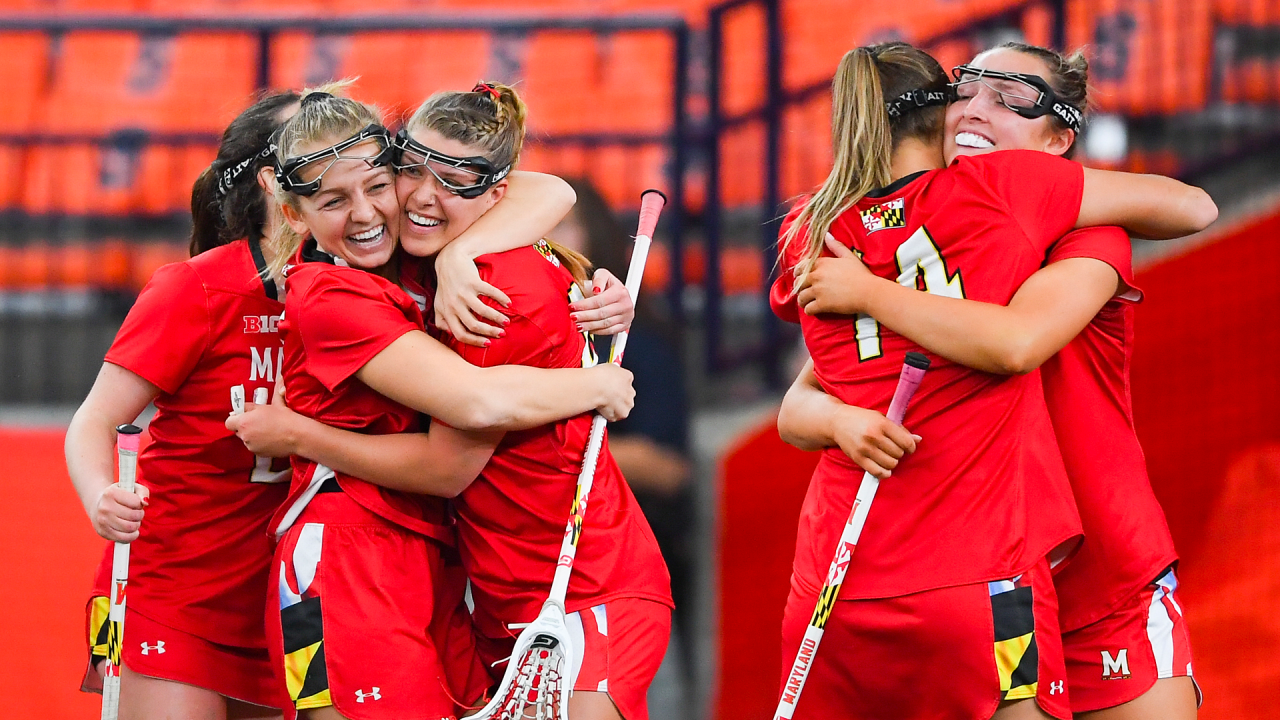 Maryland women's lacrosse players celebrate a score.
