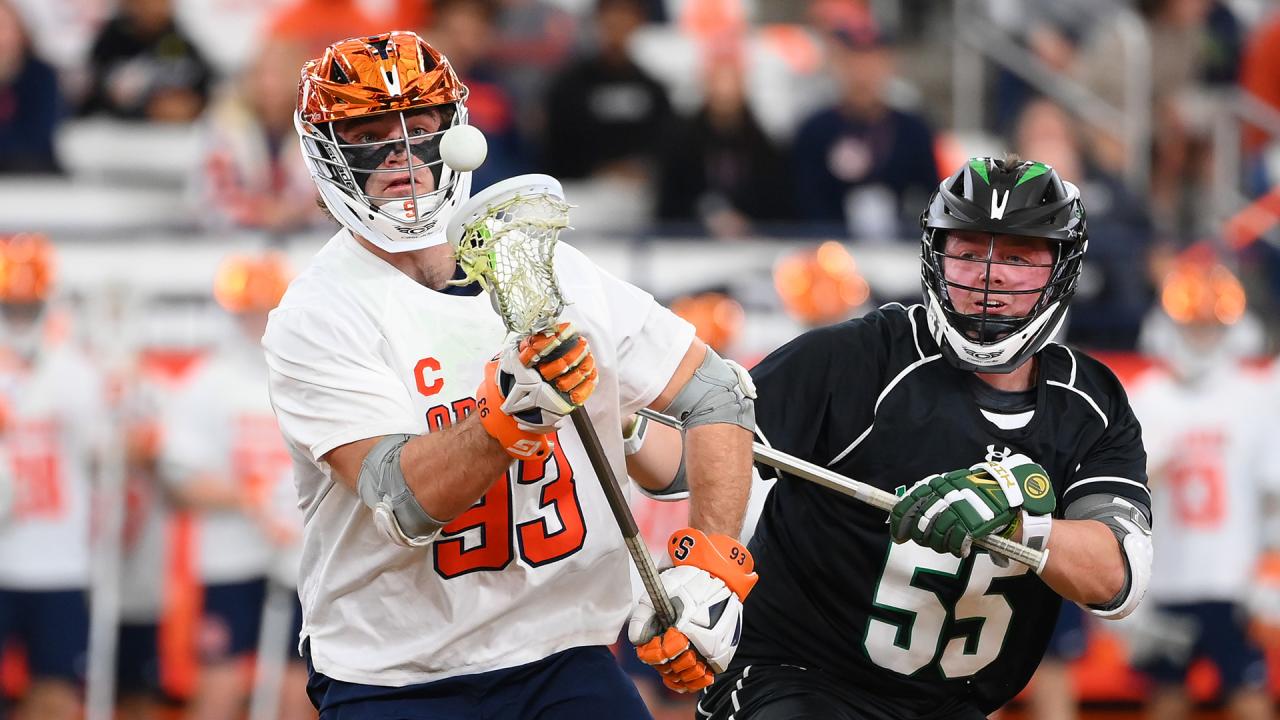 Syracuse's Mason Kohn wins a faceoff against Manhattan