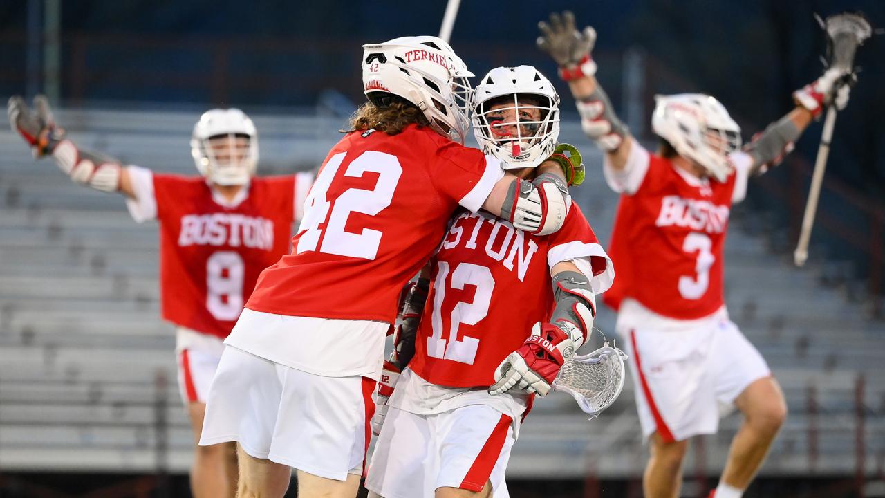 Boston University's Jake Cates (42) and Zach Travaglini (12) celebrate after Travaglini's go-ahead goal in the fourth quarter at Colgate.