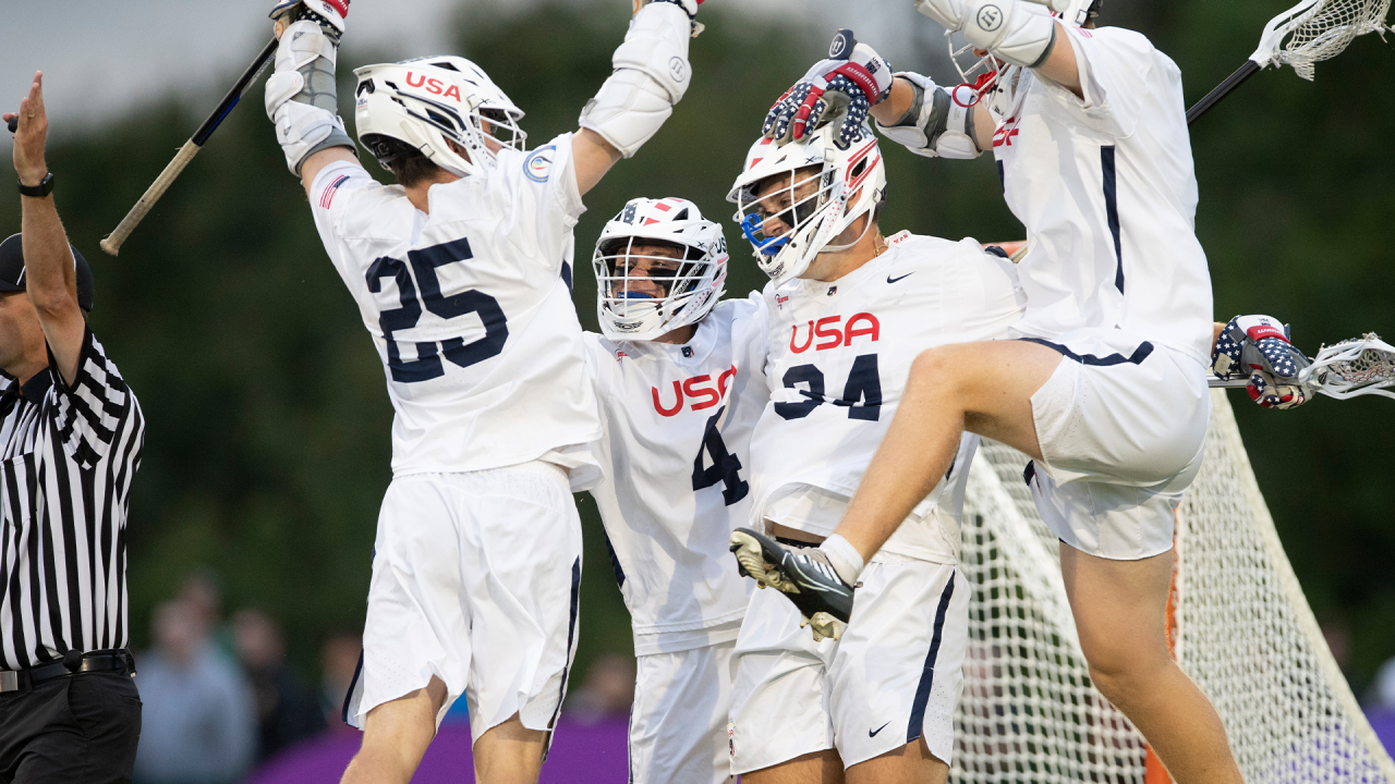 U21 men's players celebrate a goal.