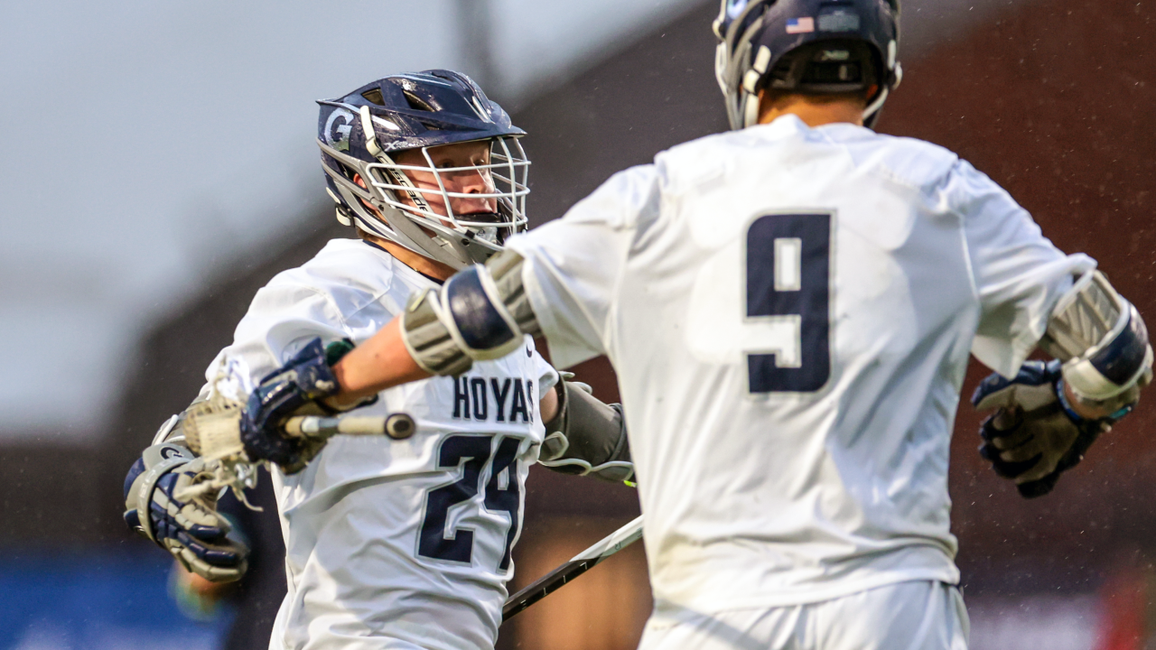 Pat Crogan (24) celebrates with Graham Bundy Jr. (9) after scoring the winning goal for Georgetown.