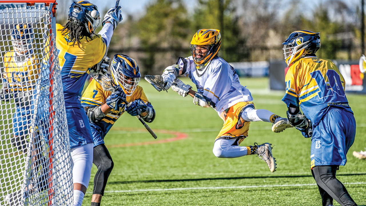 Bowie State’s Jared Morgan Jr. takes to the air to shoot past Coppin State goalie Jason Bandoh in a Next Collegiate League game at USA Lacrosse’s Tierney Field in Sparks, Md.