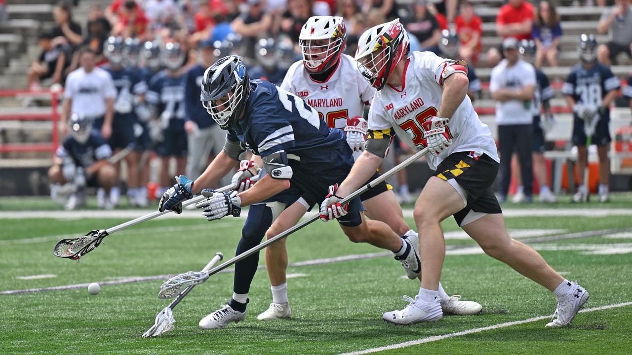 Maryland defender with check on Penn State lacrosse player.