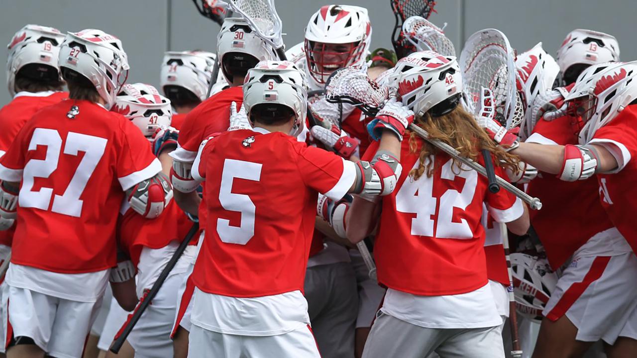Boston University men's lacrosse players celebrate after upsetting Army.
