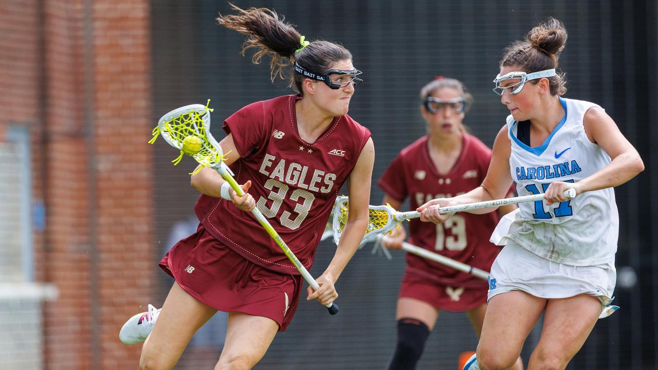 A North Carolina defender guards a Boston College offensive player in women's lacrosse.