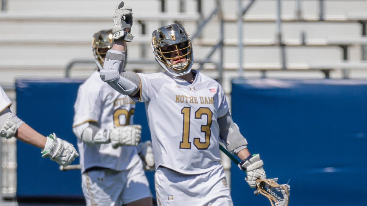 Notre Dame's Jake Taylor raises his hand after a goal from earlier this season.