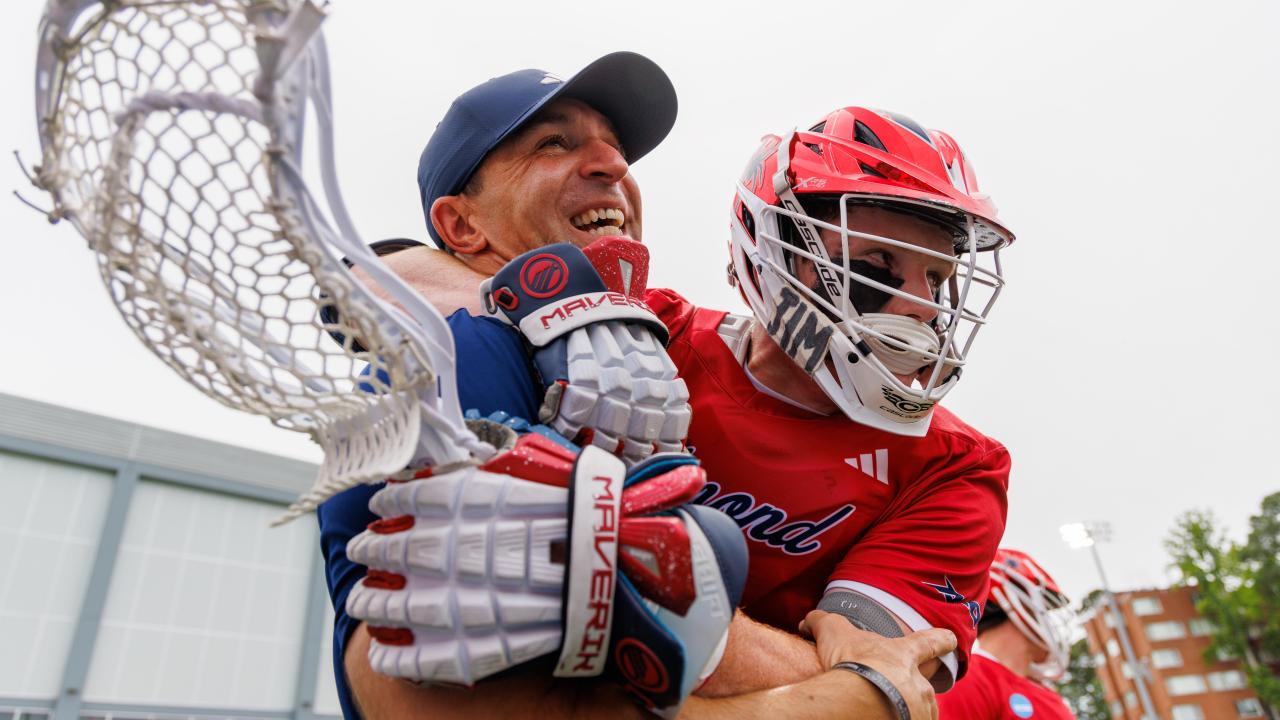 Richmond coach Dan Chemotti receives a warm embrace from one of his players as they celebrate the first NCAA tournament victory in program history.
