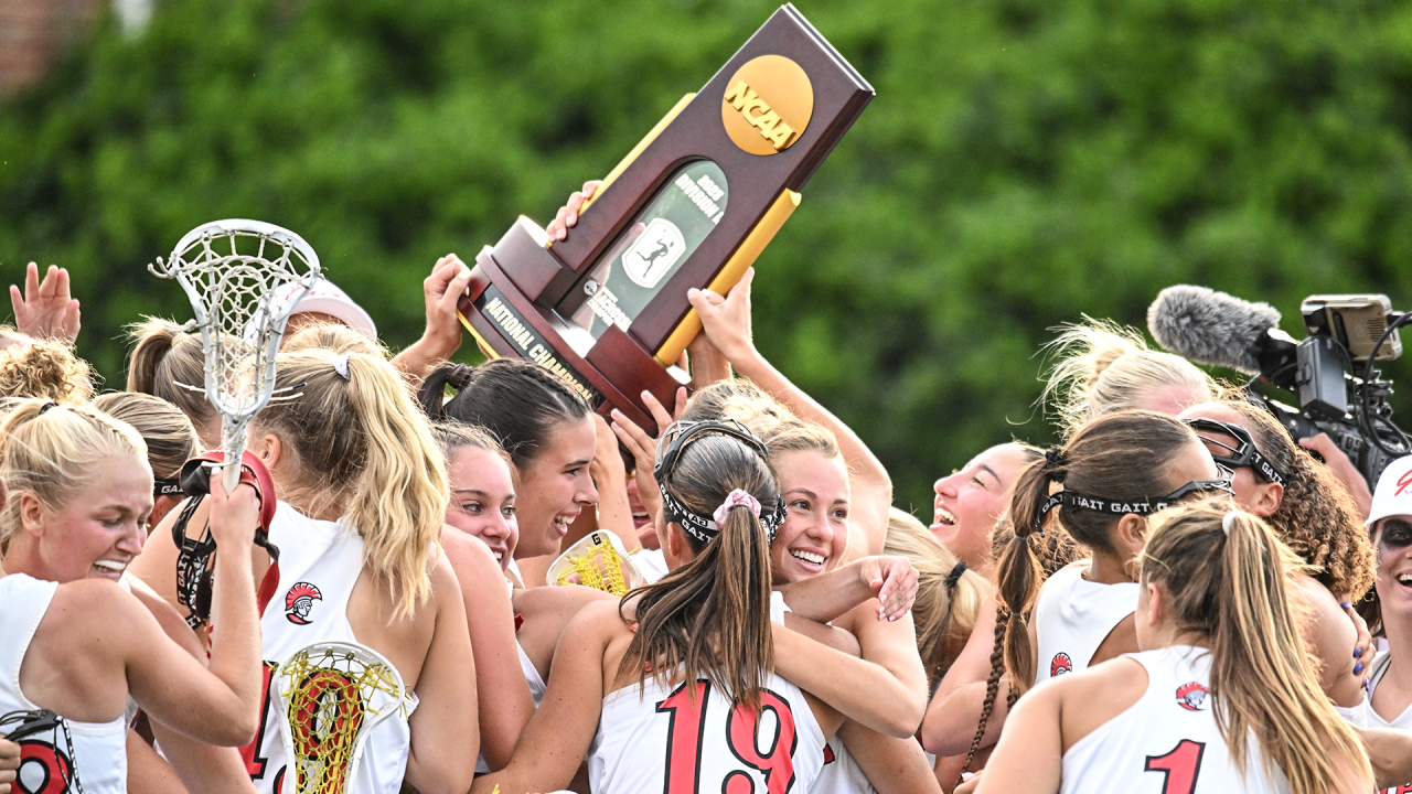 Tampa women's lacrosse players celebrate with the NCAA championship trophy in their possession at Kerr Stadium in Salem, Va.