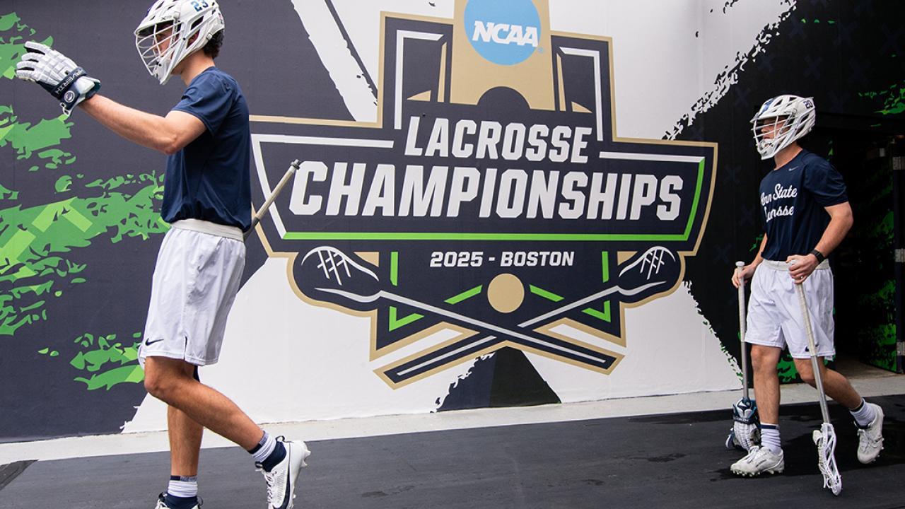 Two Penn State men's lacrosse players walk out of the tunnel ahead of the NCAA semifinals last month in Massachusetts.