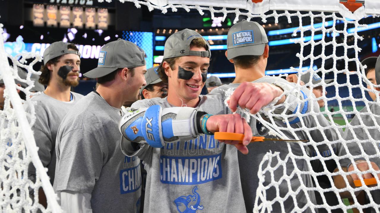 Tufts players cut down the net after the 2025 title game