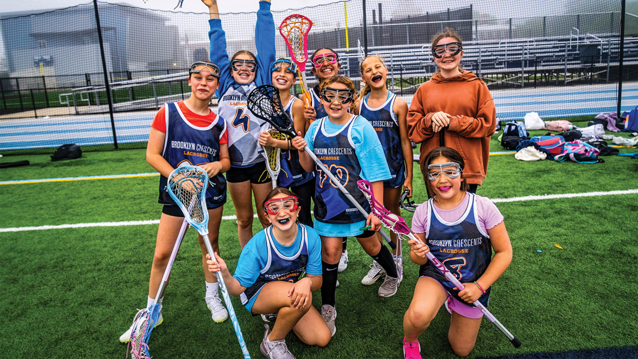 Brooklyn Crescents girls' lacrosse players pose and cheese for a photo opportunity