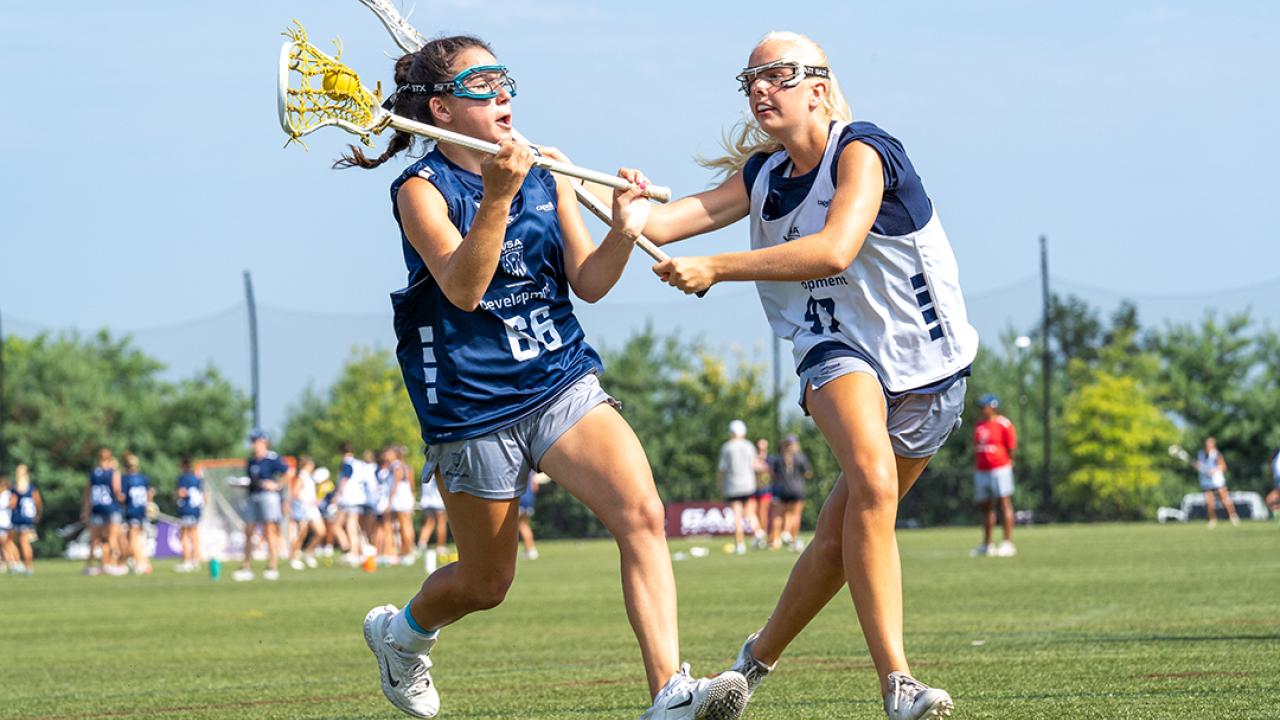 Presley Upton guards Adriana Gromelski during the USA Lacrosse girls national combine in July 2025