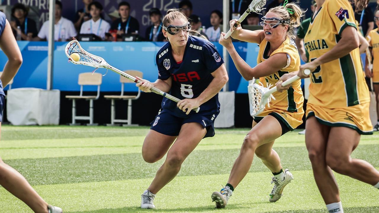 Cassidy Weeks looks for an avenue to drive through Australia's defense in lacrosse action at The World Games in China