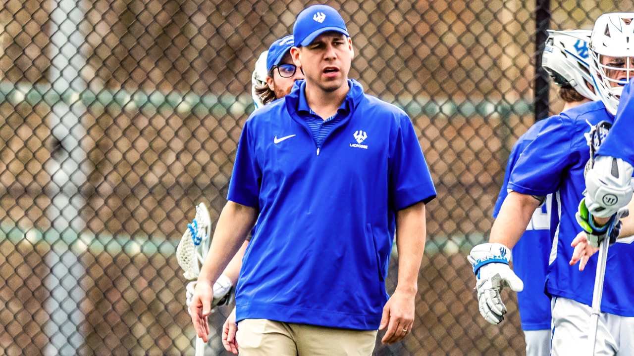 Taylor Mendoza on the Washington and Lee men's lacrosse sideline during a game