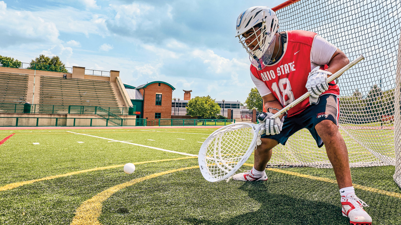 Ohio State goalie Caleb Fyock stops a shot warming up with his STX Aero helmet