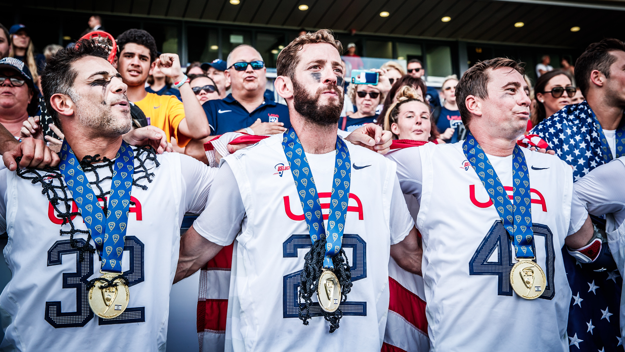 Ned Crotty (22) links arms with Greg Gurenlian (32) and Matt Danowski (40) singing the national anthem with gold medals hanging from their necks after the 2018 FIL Men's World Championship final at Netanya Stadium in Israel.
