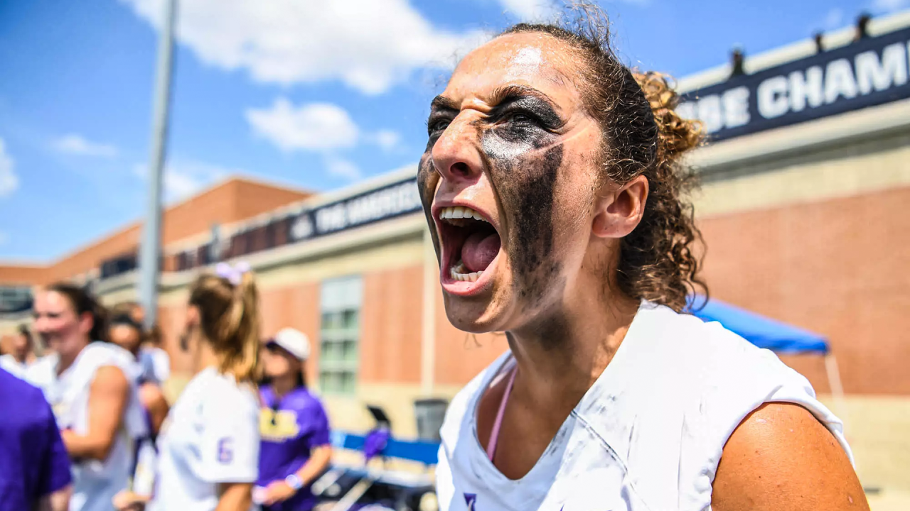 James Madison women's lacrosse player Payton Root roars in celebration after the Dukes clinched the American Conference title with a win over South Florida.
