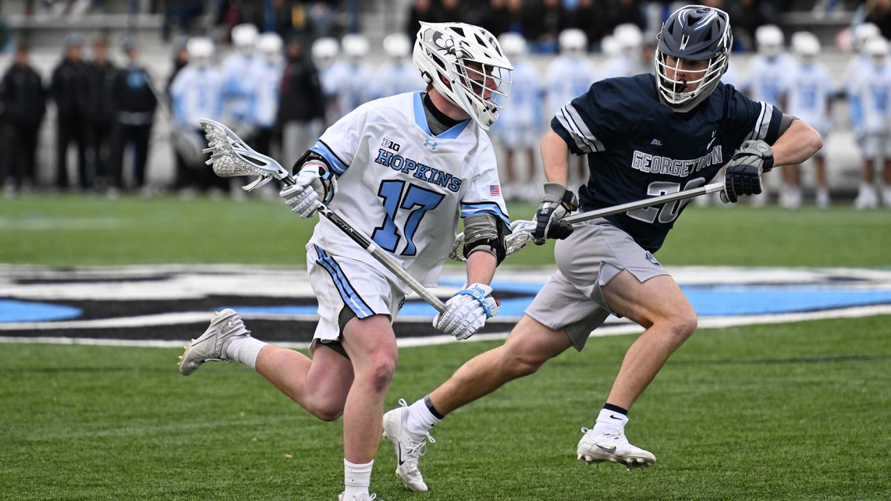 Johns Hopkins Sean Crogan runs with the lacrosse ball against Georgetown during a 2025 game