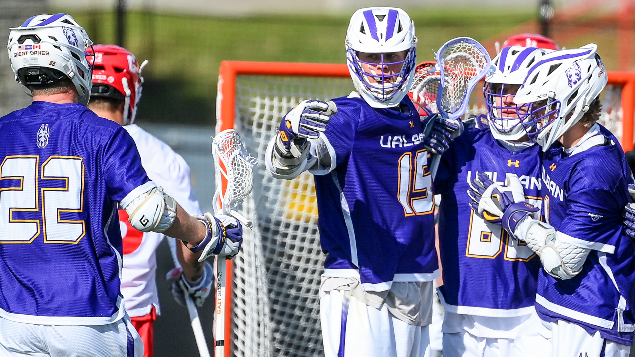 Teammates congratulate UAlbany lacrosse player Silas Richmond (15) after he scored a goal in a game at Cornell.