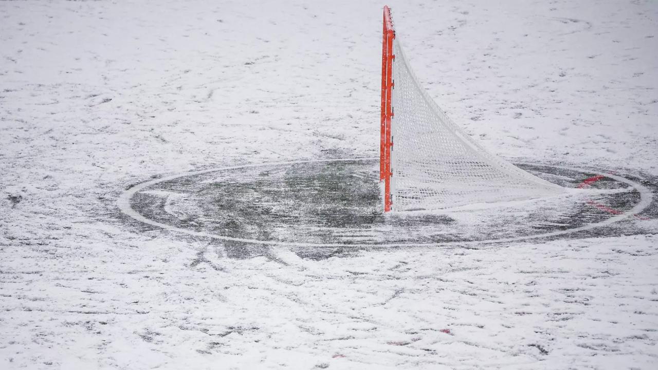 A lacrosse goal with snow surrounding it