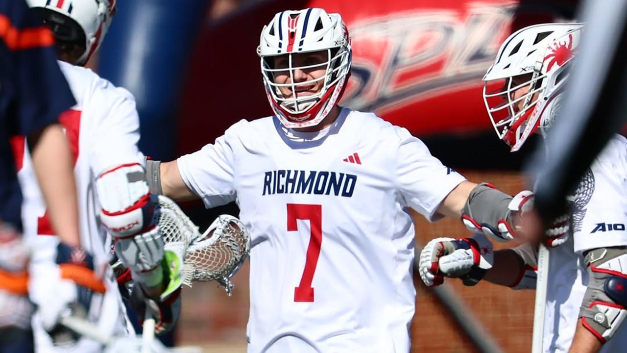 Joe Sheridan celebrates a goal with his arms out to the side.