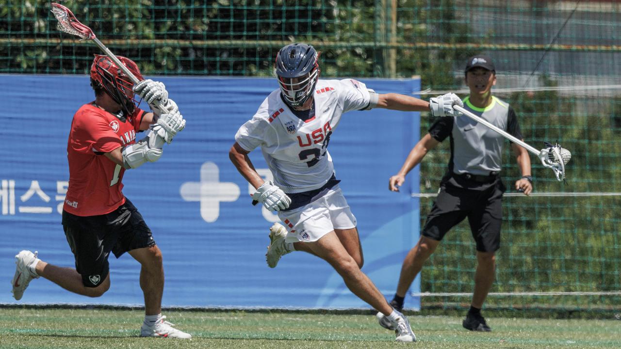 Robby Hopper extends his stick away from a Canadian defender during the world championship