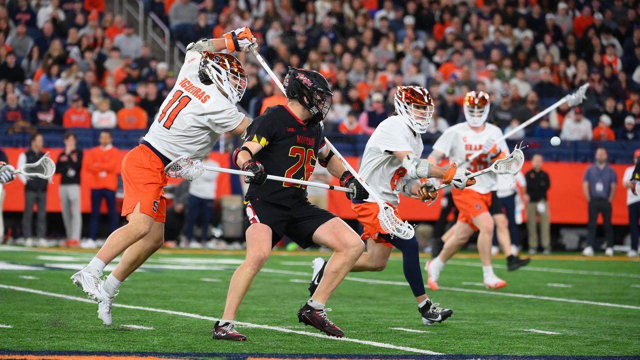 Syracuse's Riley Figueiras throws an over the head check on Maryland's A.J. Larkin